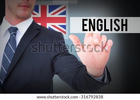 The word english and focused businessman pointing with his finger against blue background with vignette