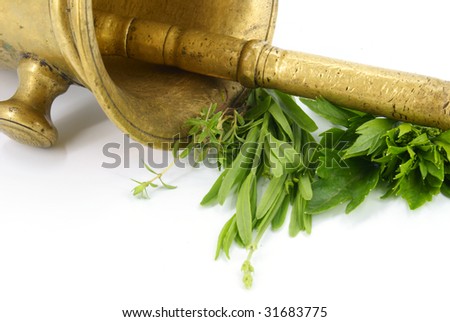 Antique mortar with aromatic herbs on white background. stock photo