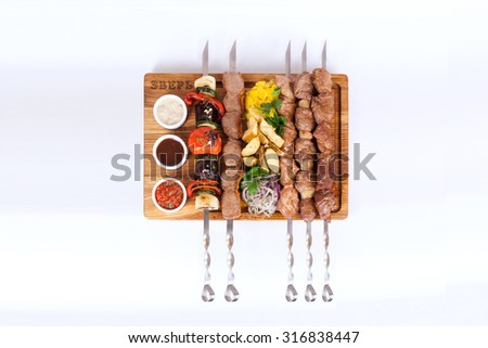 assorted kebabs on a board on a white background, skewers, food, barbecue