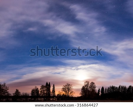 Night landscape panorama and cloudy starry sky and moon