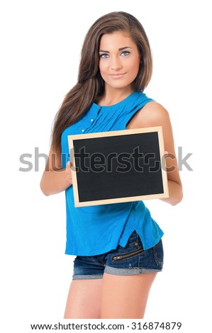 Beautiful teen girl with small blackboard posing on white background