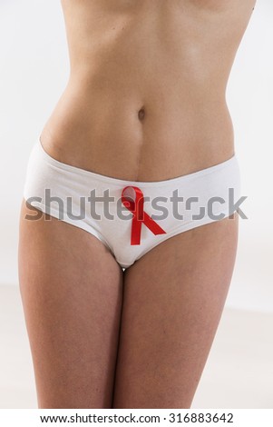 Woman with aids awareness red ribbon on her panties