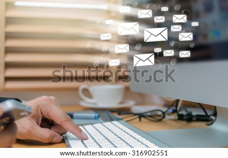 Businessman hand pressing the keyboard for sending the e-mail from computer, business technology concept