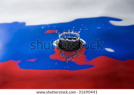 A water droplet against Russian flag colors