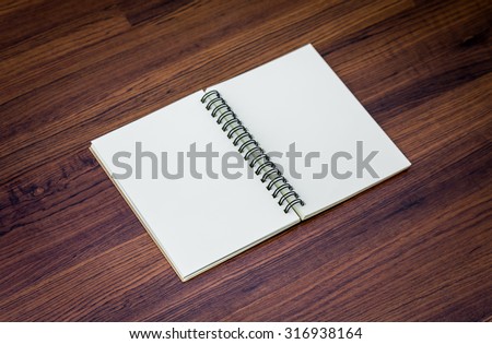 Blank notebook mock up on wood background