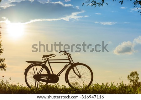beautiful landscape image with Silhouette Bicycle at sunset