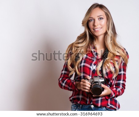 young hipster woman with digital camera smiling 