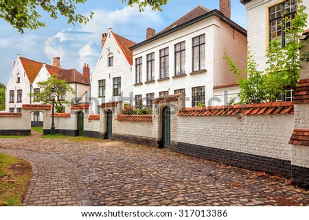 Traditional medieval red and white brickwall architecture of Bruges on blue sky background
