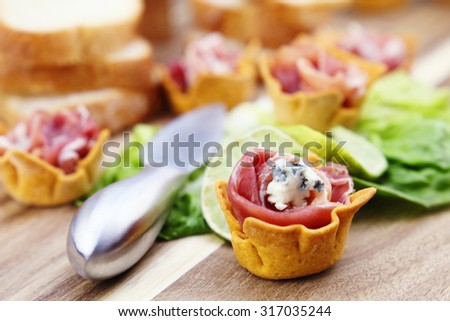 Snacks of meat with herbs.