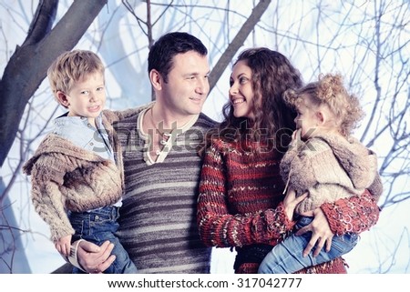 Family portrait standing on studio snow forest background