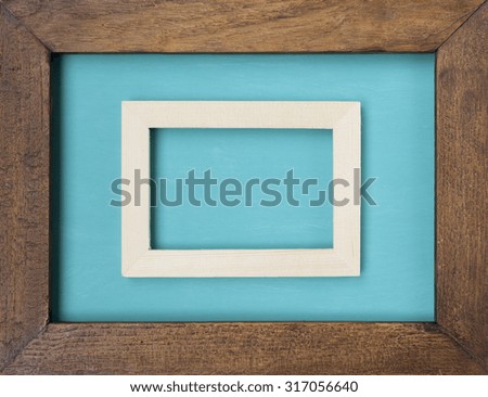 Double wooden frame on blue background