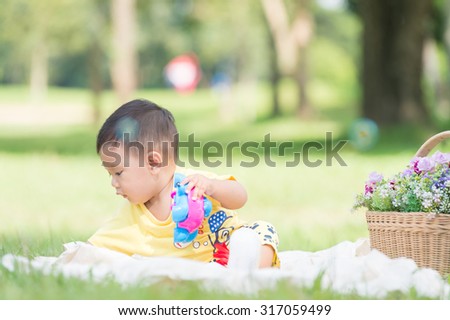 Asia Baby boy on green grass in the park , Chiangrai Thailand