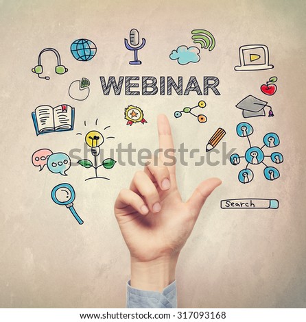 Hand pointing to Webinar concept on light brown wall background