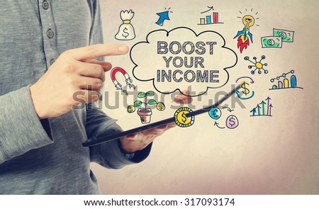 Young man pointing at Boost Your Income concept over a tablet computer