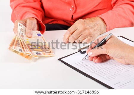 Senior woman paying for her medical bills