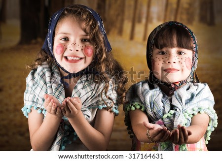 Beautiful little girls dressed as a traditional witches asking trick or treat