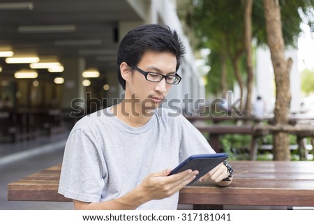 Man Use Tablet on the Bench