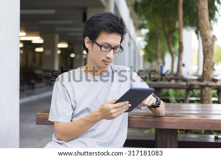 Man Use Tablet on the Bench