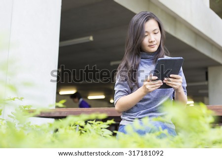 Woman Use Tablet on the Bench