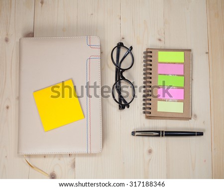 book note with post it on wood background