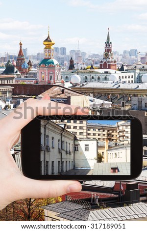 travel concept - tourist photographs picture of old Moscow urban yard on smartphone,