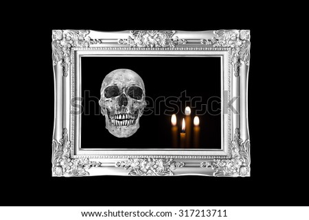 halloween concept,Silver vintage photo frame with  skull and candle background, black and white