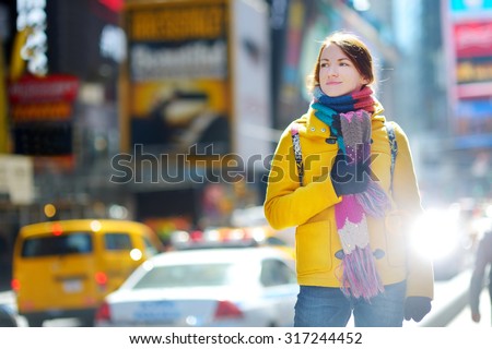 Beautiful young woman sightseeing at Times Square, New York