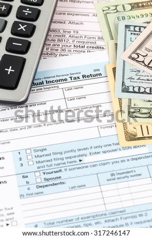 Tax form with calculator and banknote taxation concept