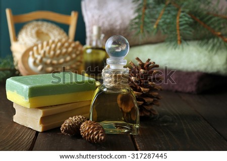 Essential oil of pine, handmade soap and cream with pine extract and spa treatments on wooden background