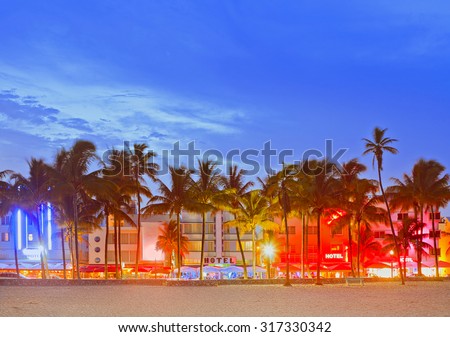Miami Beach Florida, sunset over illuminated skyline of hotels and restaurants in art deco architectural style