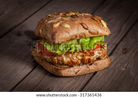 Meat burger on the wood background