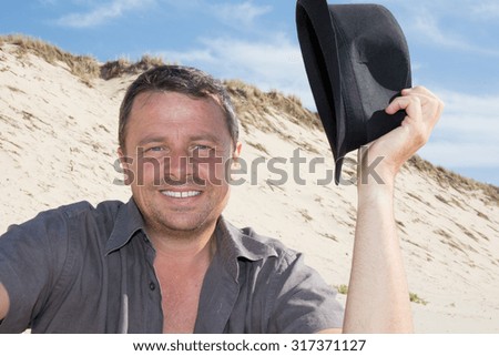 Man with a black hat at the beach