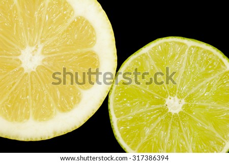 Cut lemon and lime on a black background