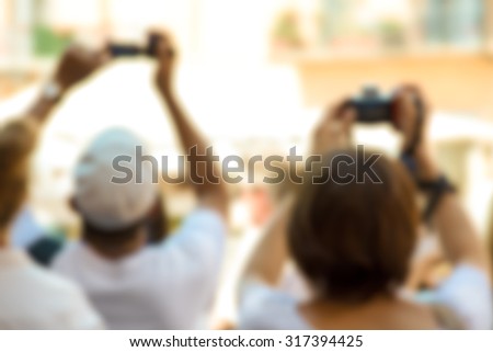 tourists making photos, blurred