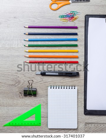 Back to school note book, pencils on wooden table