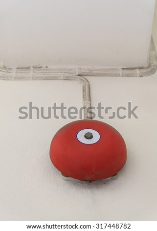 red fire alarm bell for warning security system mounted on wall