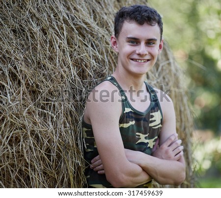Teenage boy in the countryside, in the summer holiday
