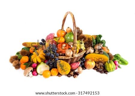 Autumn harvest - fresh autumn fruits and vegetables on wicker basket on white background