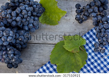 Bunches of dark grapes on a wooden table