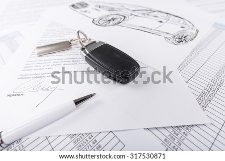 Car keys on the signed agreement document (random latin dummy text used)