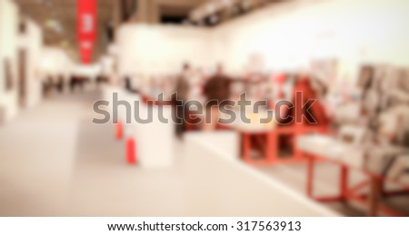 People visiting an art exhibition, generic background, intentionally blurred post production.
