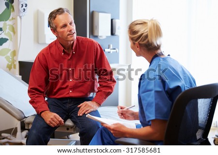 Patient And Female Doctor Have Consultation In Hospital Room
