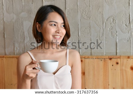 woman drinking coffee in the morning at restaurant (soft focus o