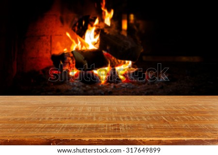 Wooden table over fireplace. Christmas holiday concept