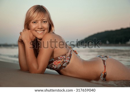 girl lying on the beach and smiling