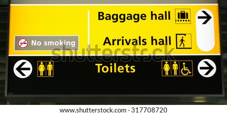 Airport baggage hall and arrivals hall with toilets sign 
