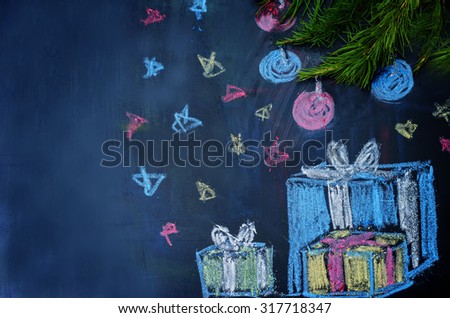 Christmas background with presents and a Christmas tree drawn with chalk on a black background. the toning. selective focus