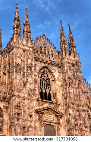 HDR photo of the famous Cathedral Duomo di Milano on piazza in Milan, Italy, during a sunset