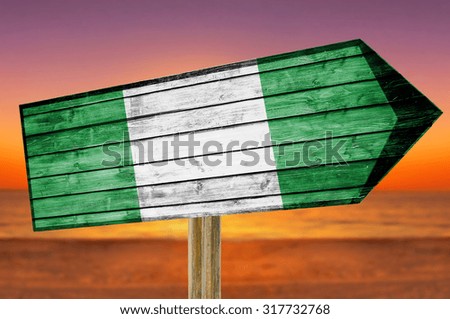 Nigeria Flag wooden sign on beach background