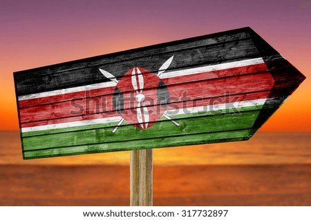 Kenya Flag wooden sign on beach background